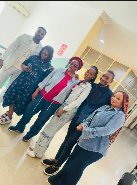 Five Cedar Microfinance Bank colleagues in relaxed denim and smart-casual outfits posing together during Customer Week 2026