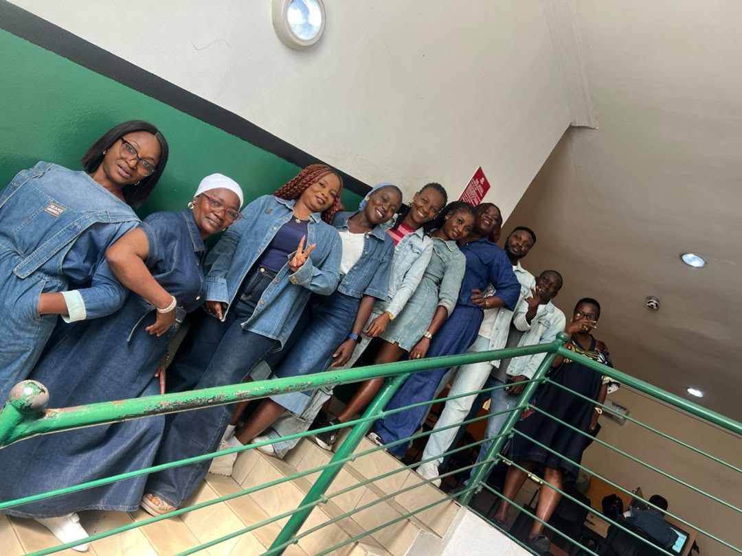 Cedar Microfinance Bank staff in denim outfits on the office staircase during Customer Week 2026